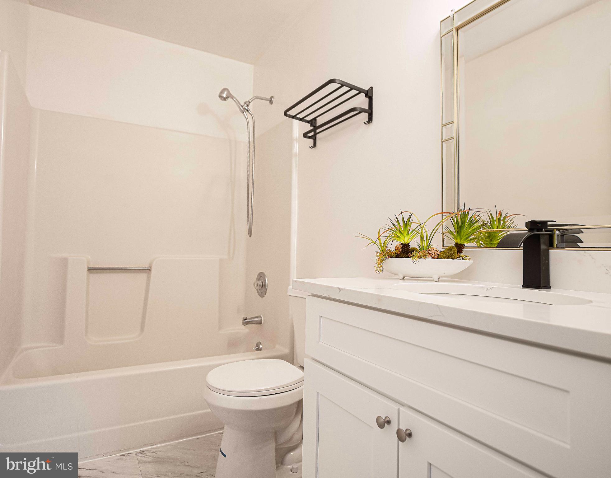 7105 Rutherford Green Circle Windsor Mill, MD 21244 - Photo 17 of 30 a bathroom with a sink a toilet and shower