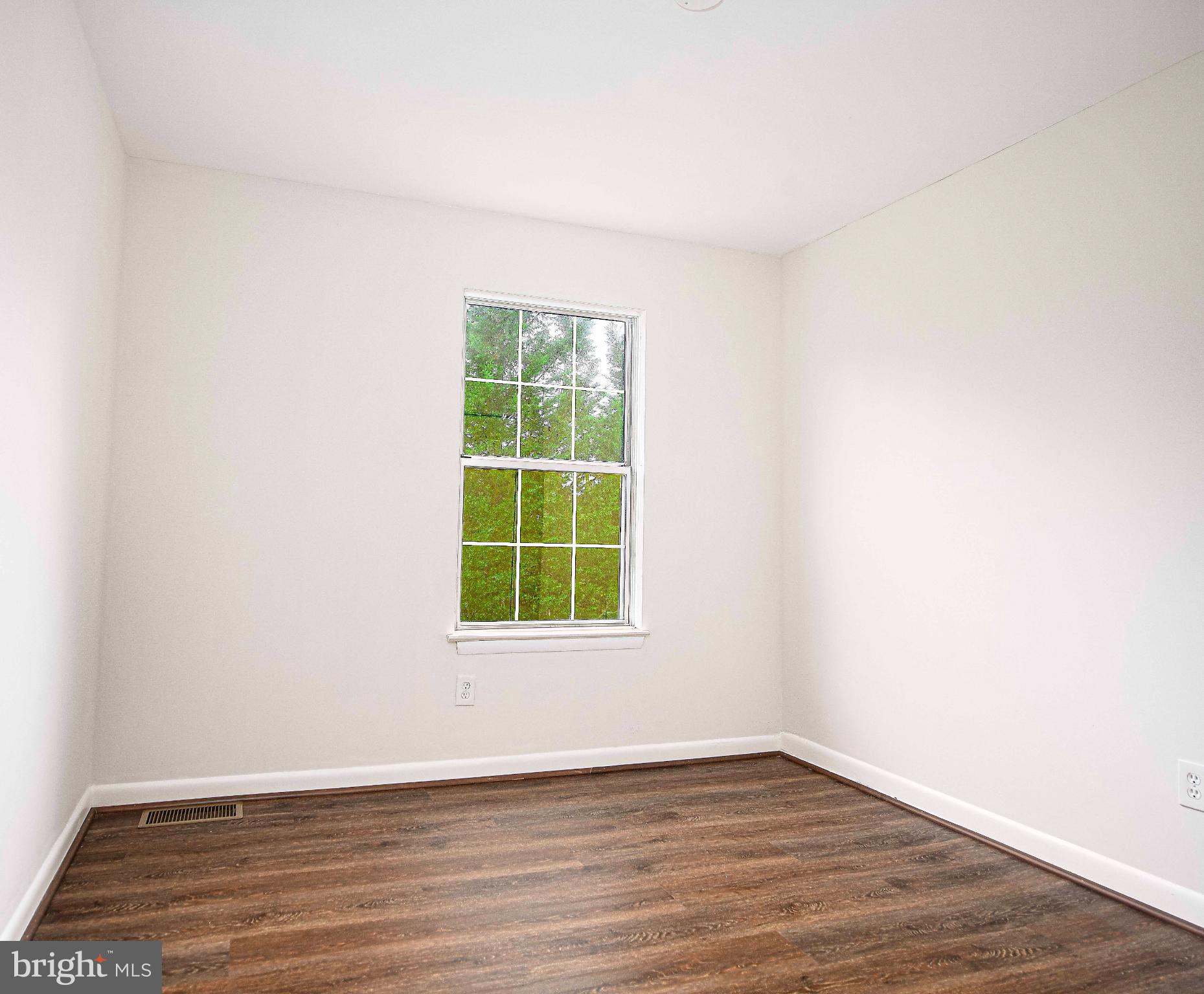 7105 Rutherford Green Circle Windsor Mill, MD 21244 - Photo 19 of 30 an empty room with wooden floor and windows