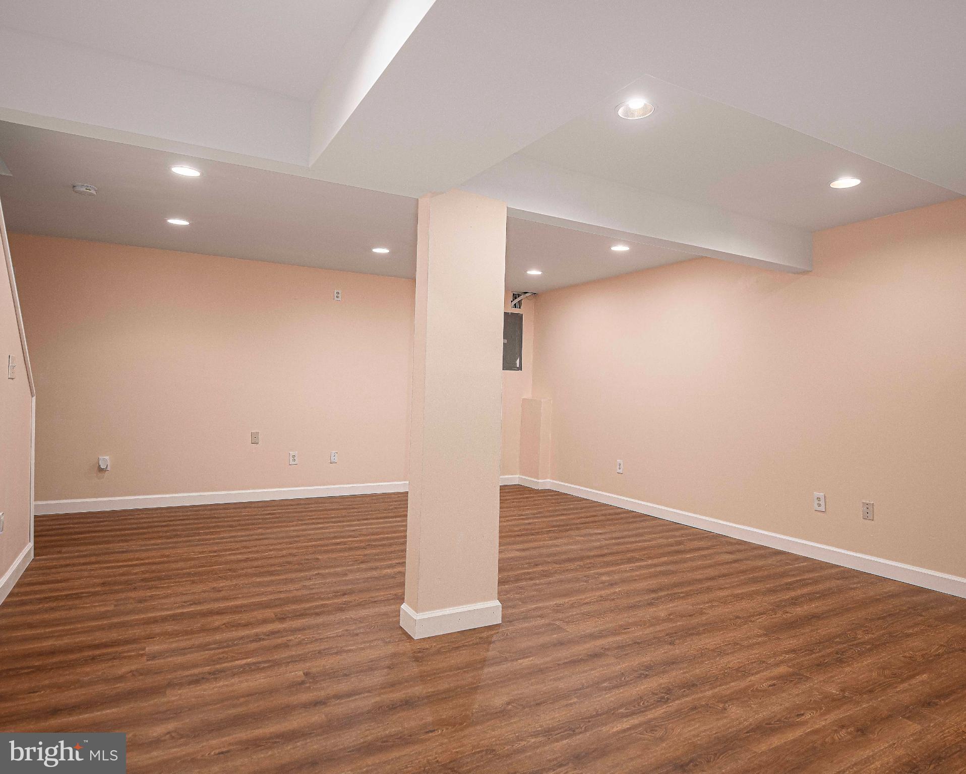 7105 Rutherford Green Circle Windsor Mill, MD 21244 - Photo 22 of 30 a view of an empty room with wooden floor