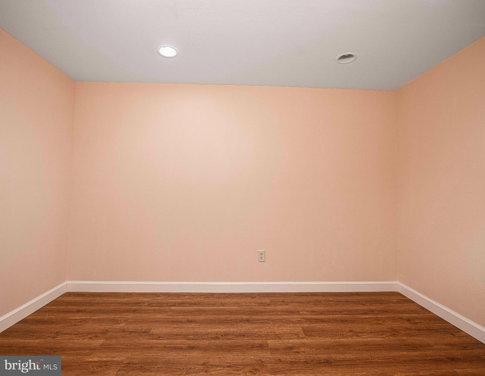 7105 Rutherford Green Circle Windsor Mill, MD 21244 - Photo 23 of 30 a view of an empty room with wooden floor