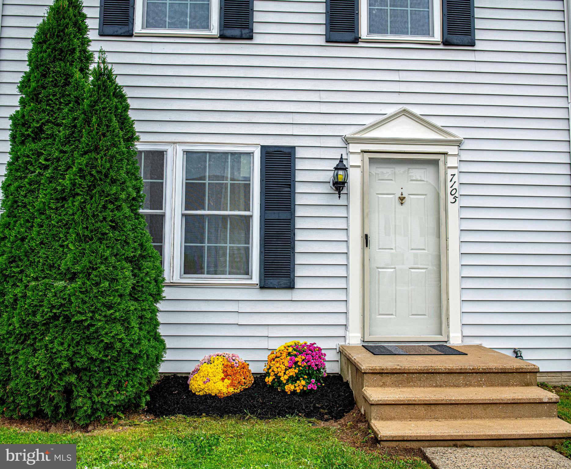 7105 Rutherford Green Circle Windsor Mill, MD 21244 - Photo 26 of 30 a front view of a house with a yard
