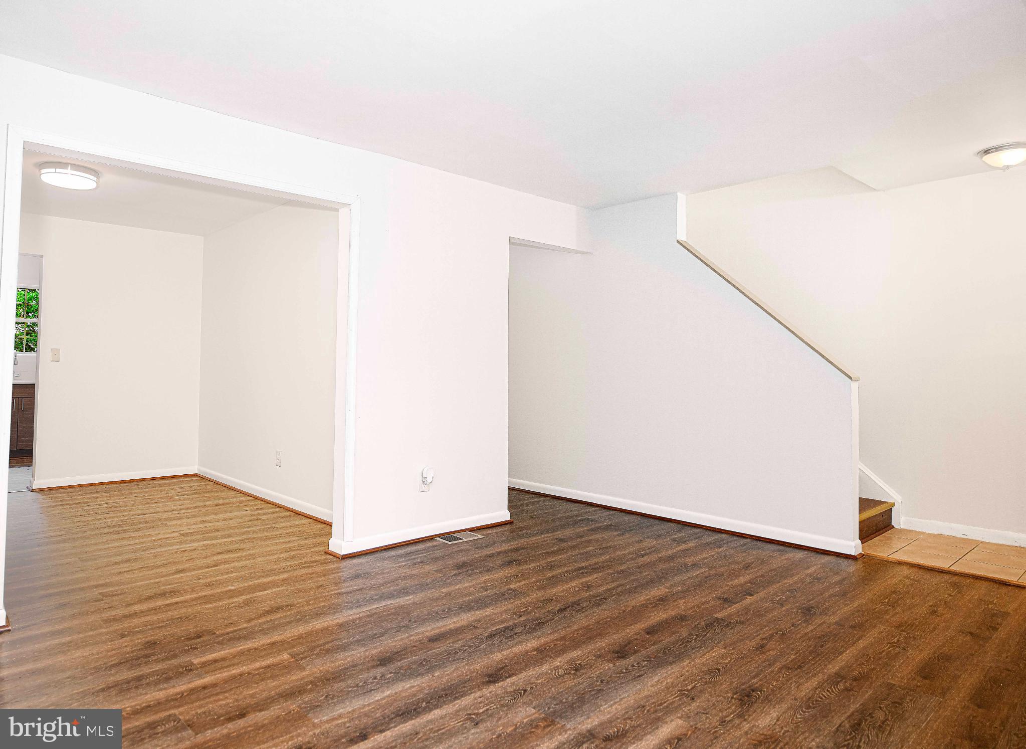 7105 Rutherford Green Circle Windsor Mill, MD 21244 - Photo 3 of 30 a view of an empty room with wooden floor