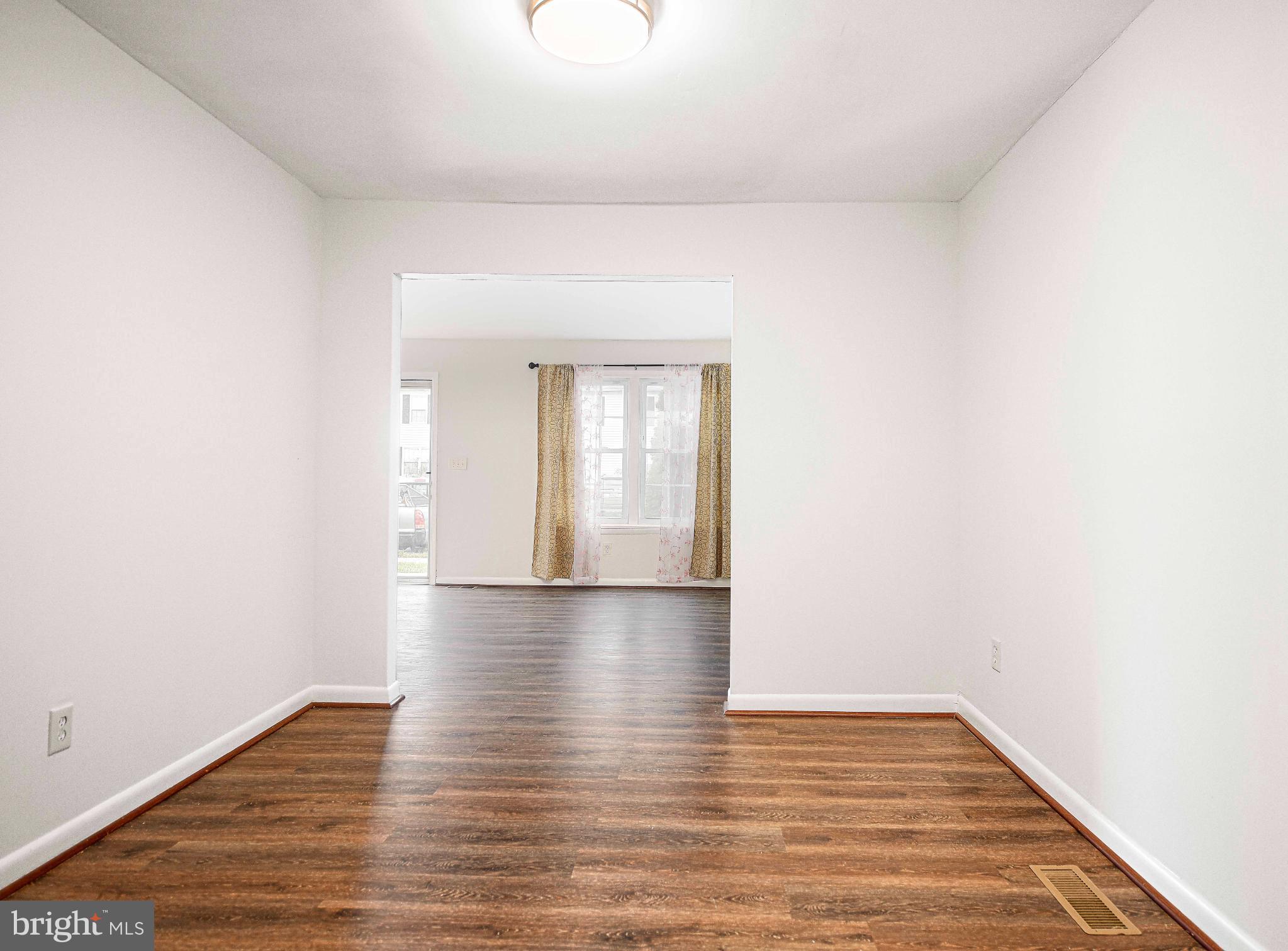 7105 Rutherford Green Circle Windsor Mill, MD 21244 - Photo 6 of 30 a view of an empty room and wooden floor