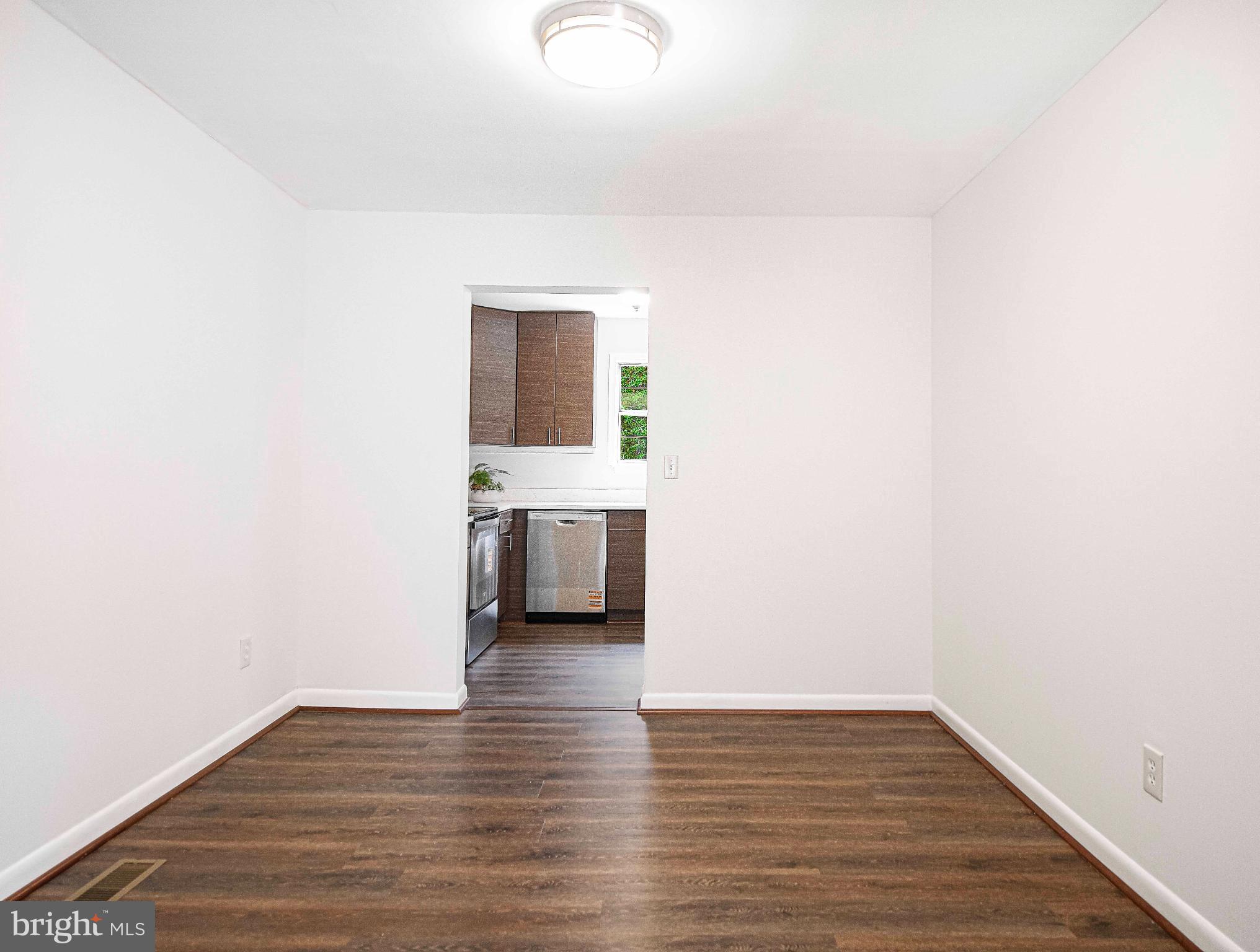 7105 Rutherford Green Circle Windsor Mill, MD 21244 - Photo 7 of 30 a view of a room with wooden floor and a sink