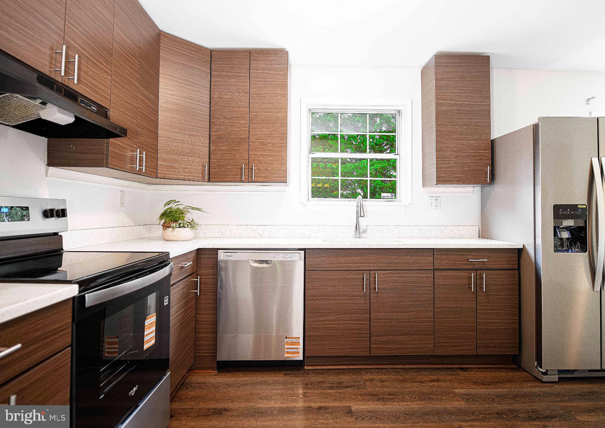 7105 Rutherford Green Circle Windsor Mill, MD 21244 - Photo 9 of 30 a kitchen with stainless steel appliances granite countertop a sink a stove a refrigerator and wooden cabinets