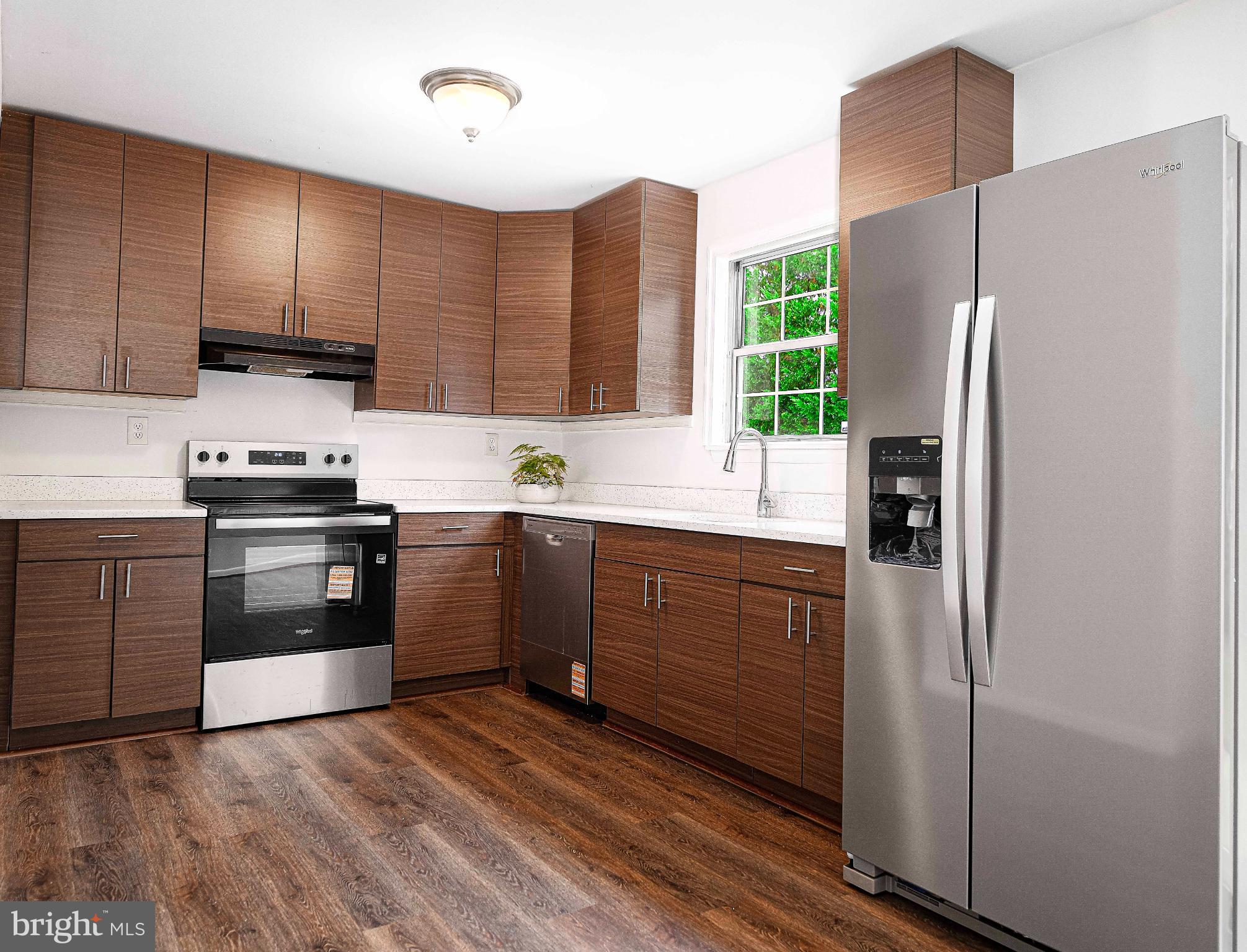 7105 Rutherford Green Circle Windsor Mill, MD 21244 - Photo 10 of 30 a kitchen with stainless steel appliances a refrigerator sink and cabinets