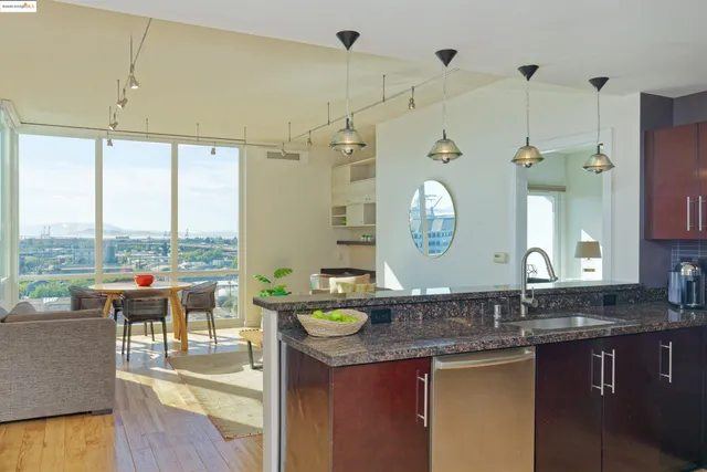 a living room with granite countertop a couch a dining table and chairs