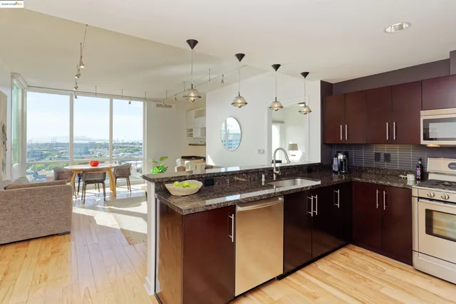 a kitchen with a sink stove and wooden cabinets