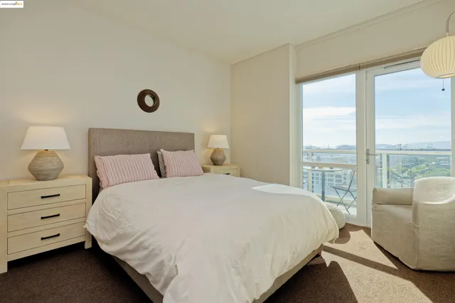 a bedroom with a bed and large window