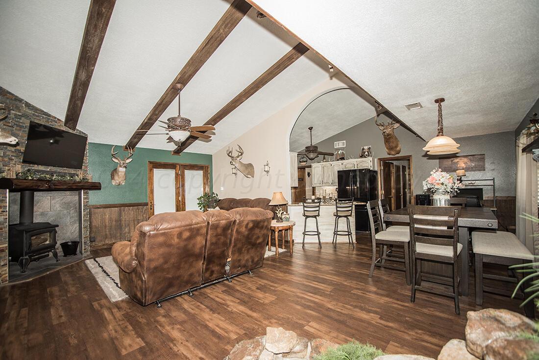 303 Cedar Fritch, TX 79036 - Photo 12 of 44 a living room with furniture a fireplace and a flat screen tv