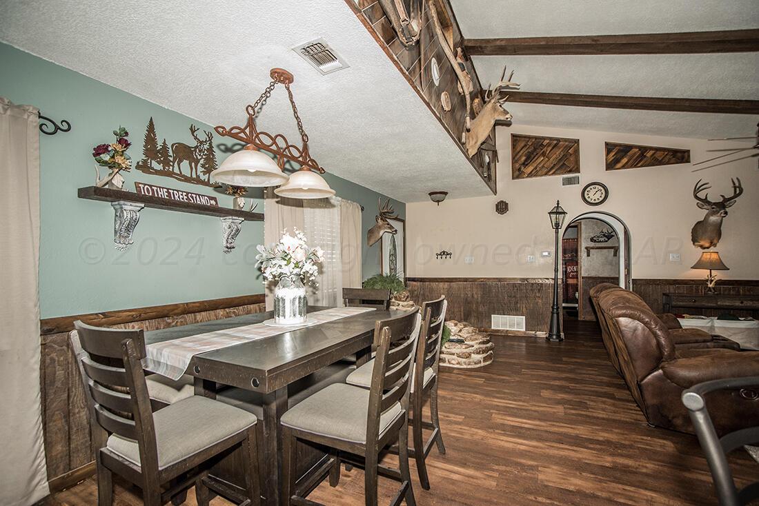 303 Cedar Fritch, TX 79036 - Photo 13 of 44 a view of a dining room with furniture and wooden floor