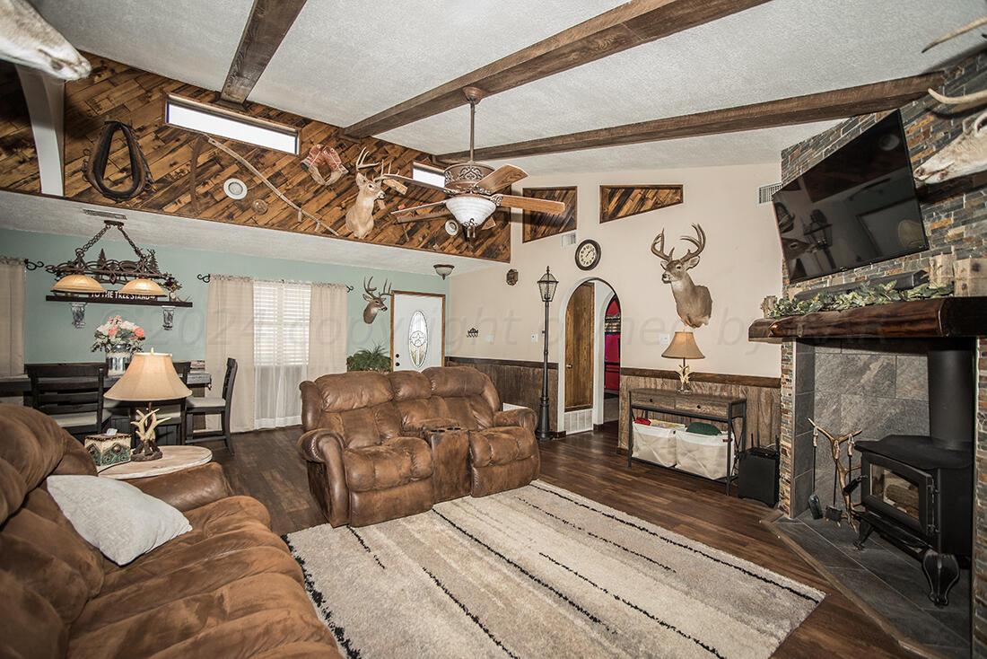 303 Cedar Fritch, TX 79036 - Photo 15 of 44 a living room with furniture a fireplace and flat screen tv