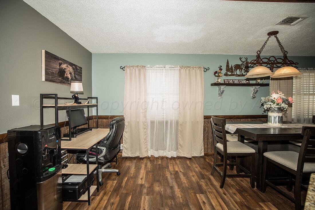 303 Cedar Fritch, TX 79036 - Photo 17 of 44 a view of a workspace with furniture and wooden floor