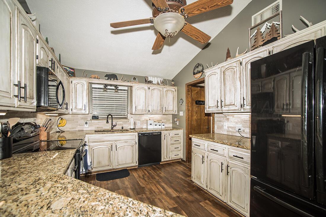 303 Cedar Fritch, TX 79036 - Photo 20 of 44 a kitchen with a sink stainless steel appliances and cabinets