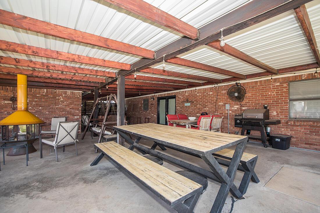303 Cedar Fritch, TX 79036 - Photo 31 of 44 a view of a patio with a table and chairs under an umbrella