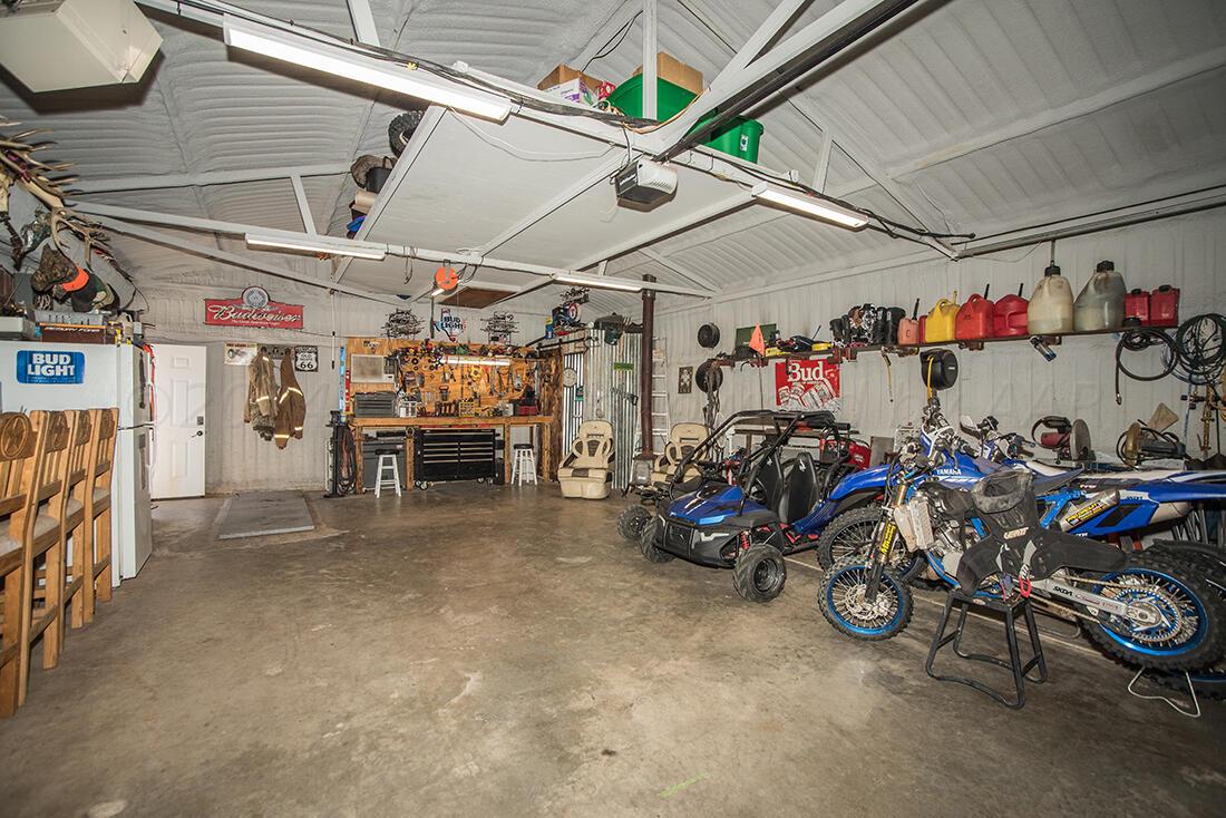 303 Cedar Fritch, TX 79036 - Photo 36 of 44 a view of a garage with a bike and car
