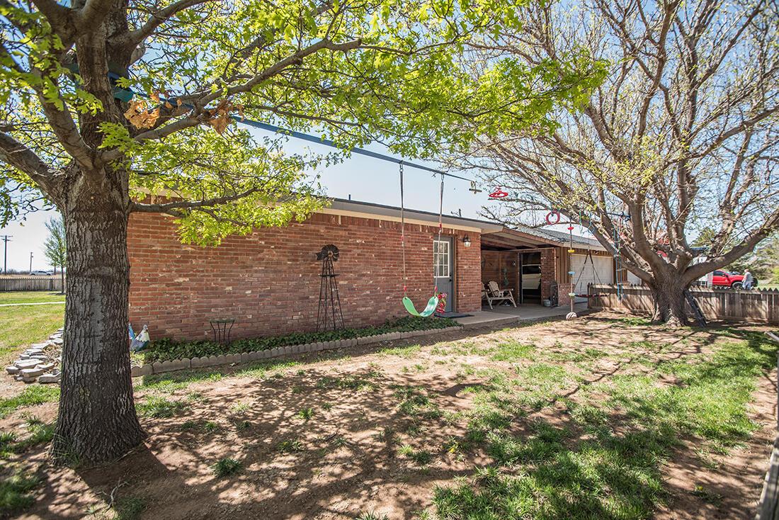 303 Cedar Fritch, TX 79036 - Photo 7 of 44 a view of a yard with a tree in the house