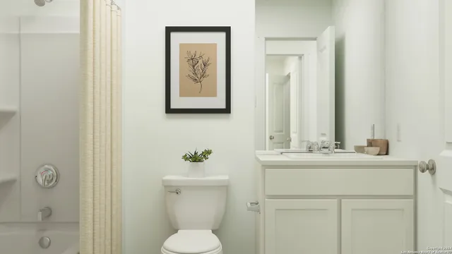 a bathroom with a toilet sink vanity and mirror