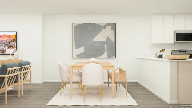 a dining room with furniture and wooden floor