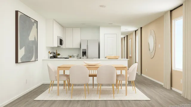 a dining room with stainless steel appliances a table and chairs