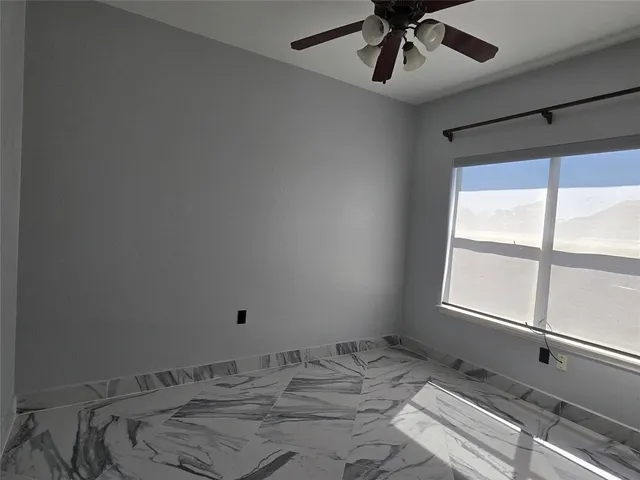 a view of a room that has a bed and a window