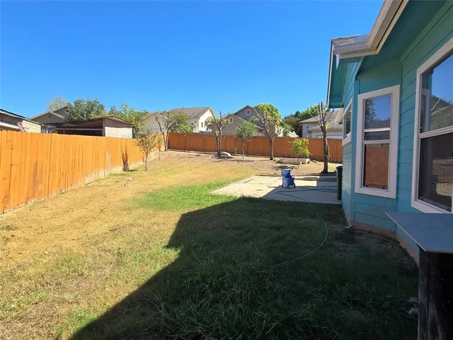 a view of a backyard with a large tree