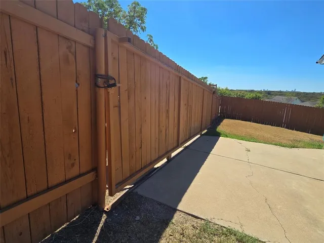 a view of a yard with plants and trees