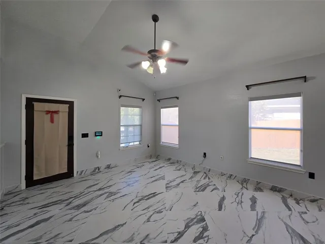 a bathroom with a granite countertop sink and a window