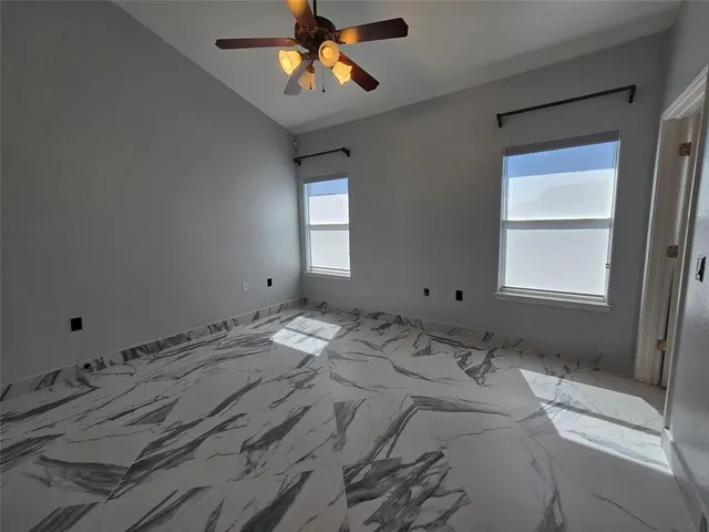 a view of a bedroom with a bed and wooden floor
