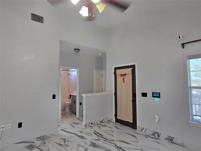 a view of a hallway with wooden floor and cabinet