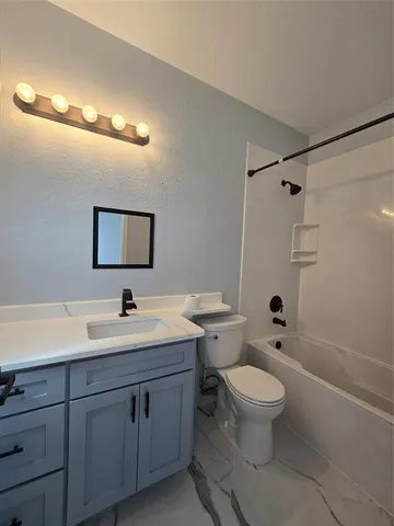 a bathroom with a toilet a sink and a mirror