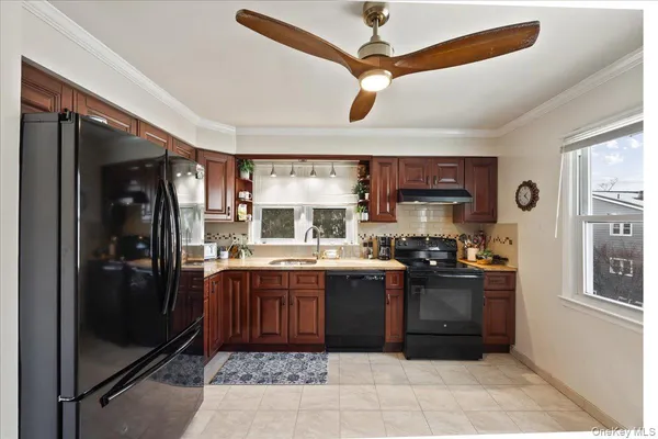 a kitchen with stainless steel appliances granite countertop a stove refrigerator and cabinets