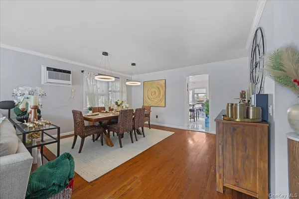a view of a dining room with furniture and wooden floor