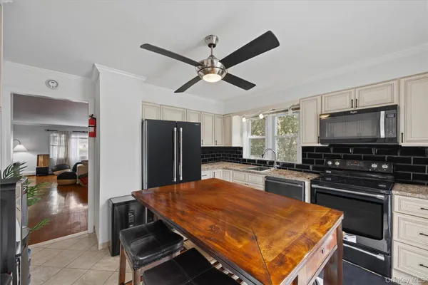 a kitchen with stainless steel appliances a stove a sink island and a refrigerator