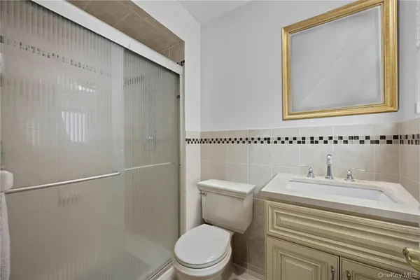 a bathroom with a sink a toilet and mirror