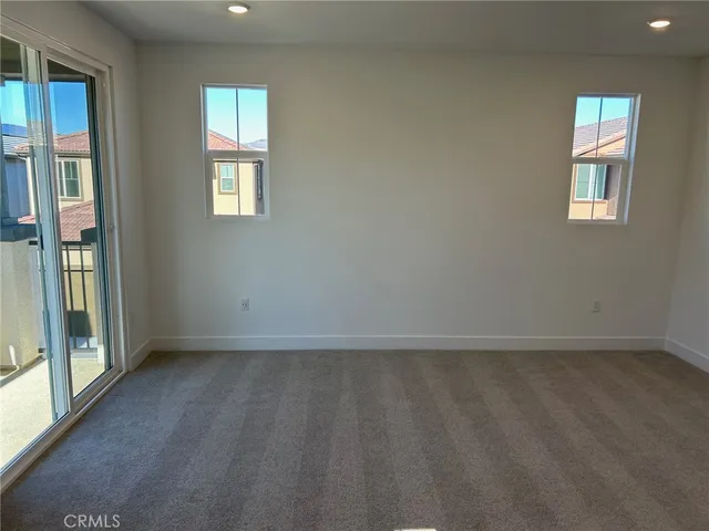 a view of balcony with wooden floor and furniture