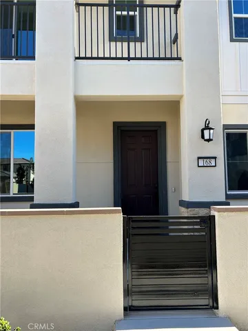 a front view of a house with plants