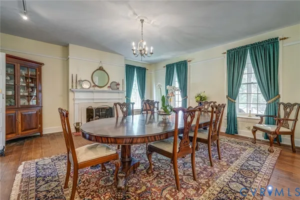 a view of a a dining room with furniture window and wooden floor