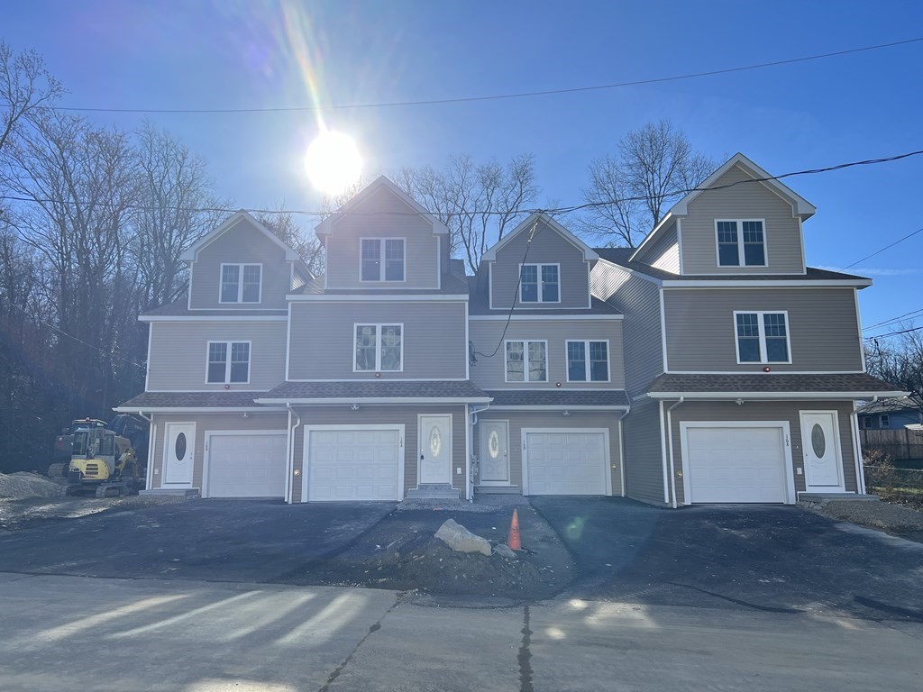 a front view of residential houses with yard