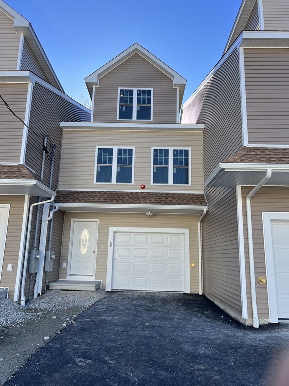 16 B Taunton Street Worcester, MA 01604 - Photo 2 of 12 a front view of a house with a yard and garage