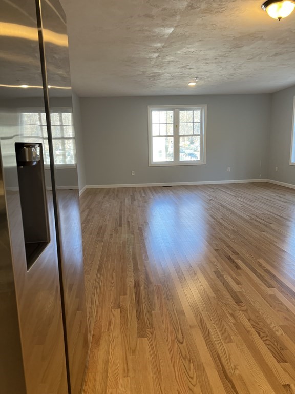 16 B Taunton Street Worcester, MA 01604 - Photo 4 of 12 a view of an empty room with wooden floor and a window