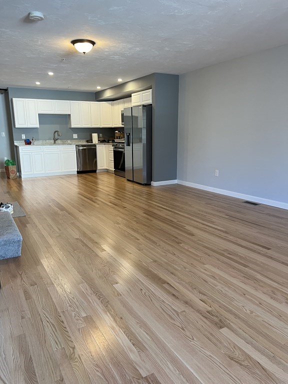 16 B Taunton Street Worcester, MA 01604 - Photo 5 of 12 a view of kitchen with furniture and wooden floor