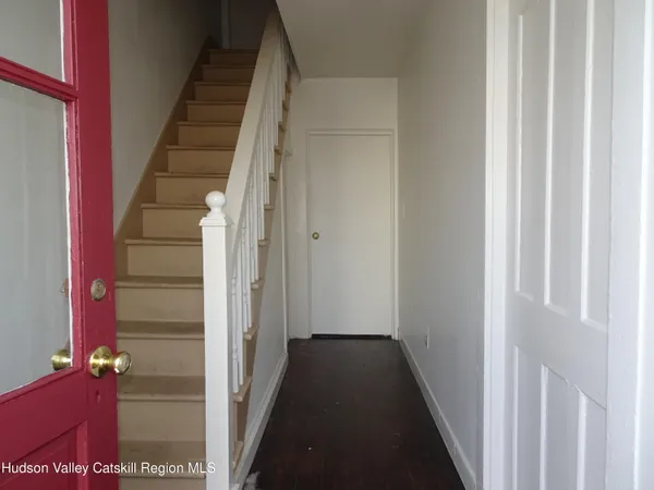 a view of a hallway with entryway door