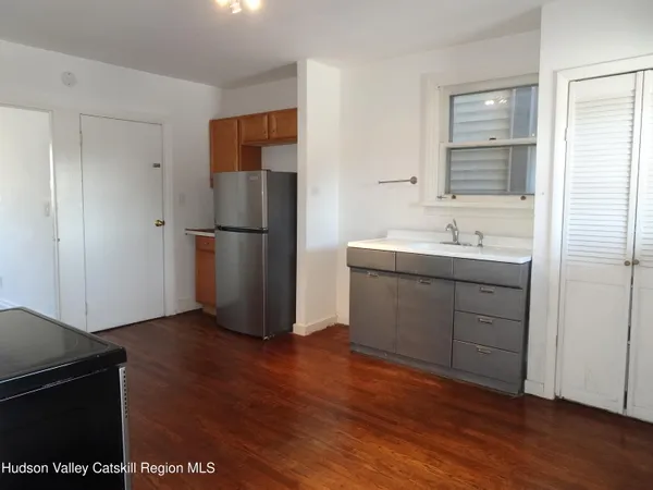 a kitchen with a refrigerator and a sink