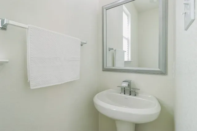 a bathroom with a sink a mirror and a window