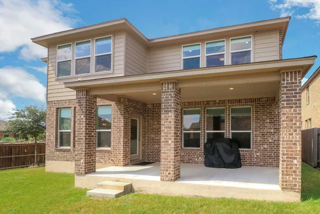 a view of a house with backyard and porch