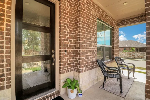 a balcony with table and chairs
