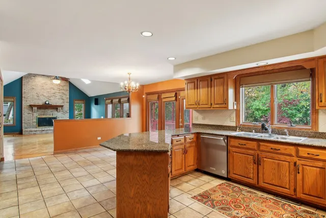 a kitchen with granite countertop a sink and cabinets