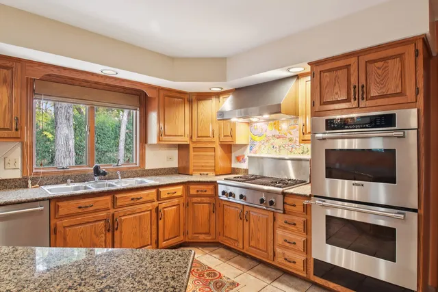 a kitchen with granite countertop a sink and a window