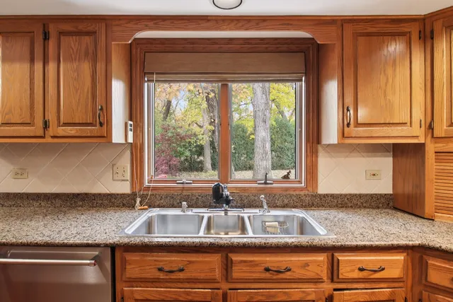 a kitchen with stainless steel appliances granite countertop a refrigerator and a stove